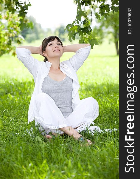 Happy young woman relaxing on grass. Happy young woman relaxing on grass