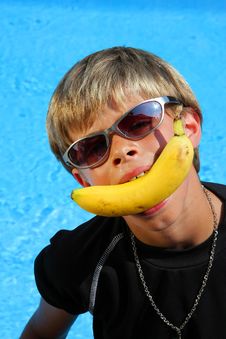 Boy With Sun Glasses And Banana Stock Photo