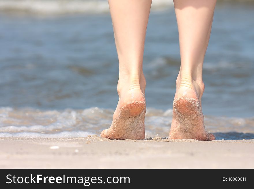 Beautiful legs on beach sand. Beautiful legs on beach sand