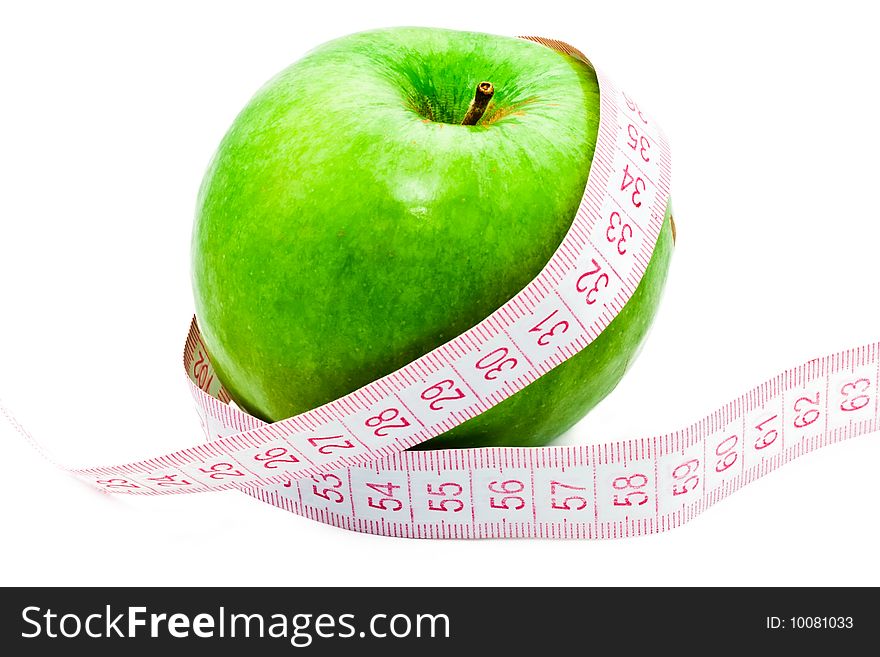 Measuring a green apple on white background