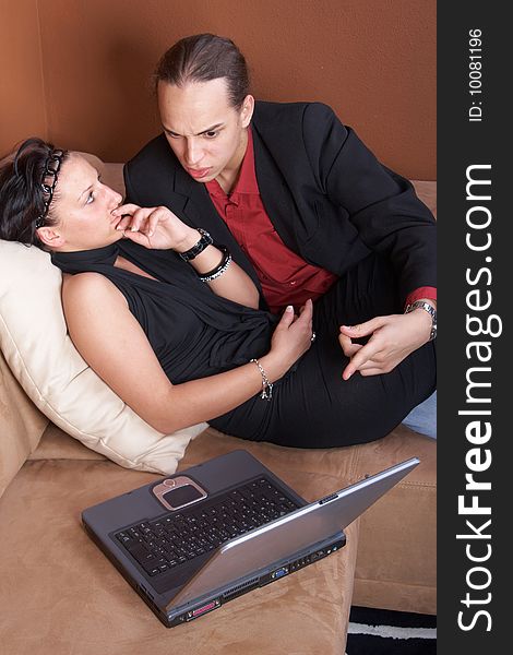 Young couple on the couch surfing the web with their laptop. Young couple on the couch surfing the web with their laptop.