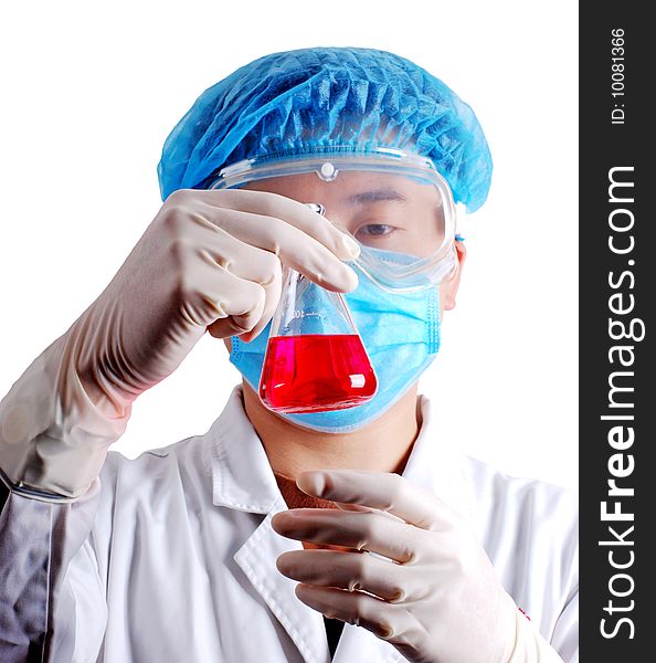 Chemist holding flask with red liquid