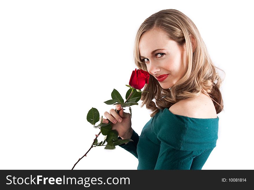 A pretty blonde girl smelling a rose on a white isolated background. A pretty blonde girl smelling a rose on a white isolated background