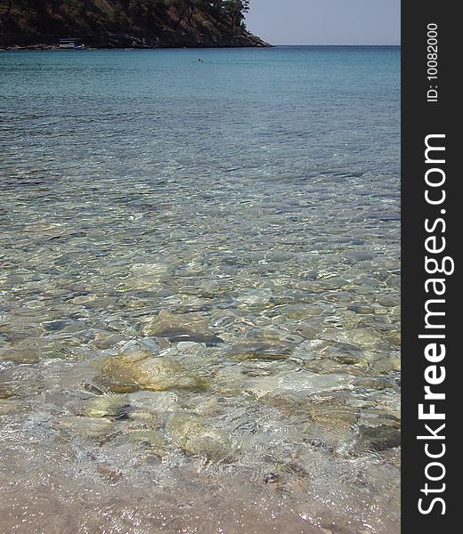 Taken in Aliki, on Thassos in Greece.  Only one swimmer out so the sea was undisturbed.  I saw how clear and rocky it was so took the opportunity of capturing it. Taken in Aliki, on Thassos in Greece.  Only one swimmer out so the sea was undisturbed.  I saw how clear and rocky it was so took the opportunity of capturing it.