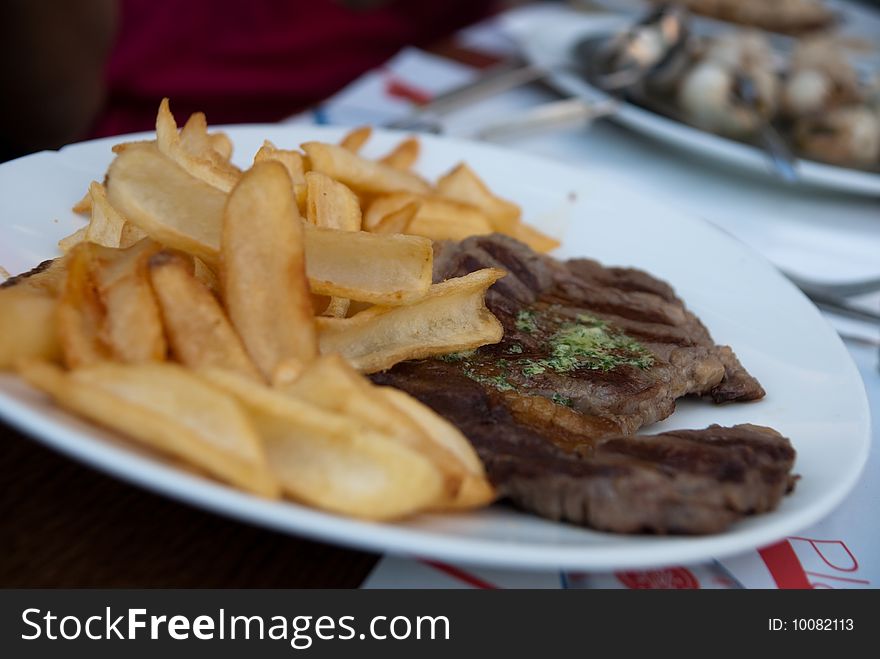 Frencn meal with beef and golden potato fries. Frencn meal with beef and golden potato fries