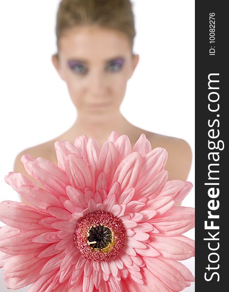Female model holding a pink flower with strong eye makeup, on a white background. Female model holding a pink flower with strong eye makeup, on a white background