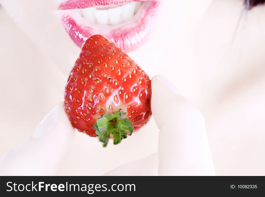 Close up of woman eating a strawberry. Close up of woman eating a strawberry