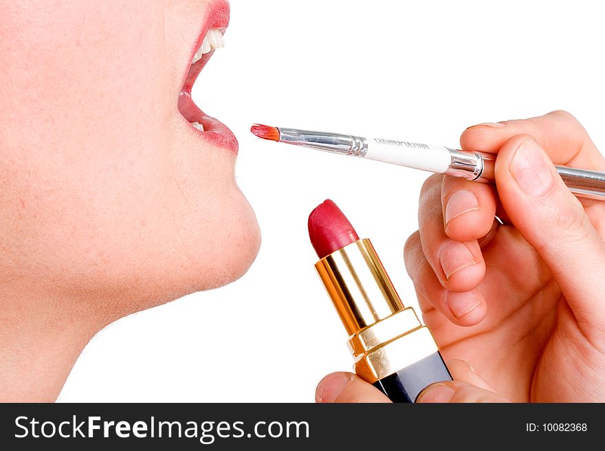 Cosmetics being applied to female model on white background. Cosmetics being applied to female model on white background