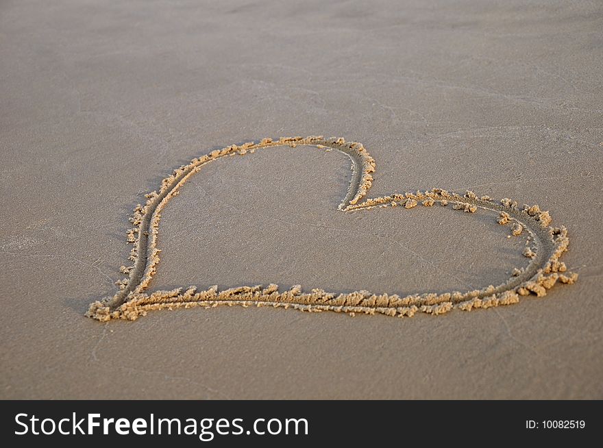 Sand drawing hearts on sand. Sand drawing hearts on sand