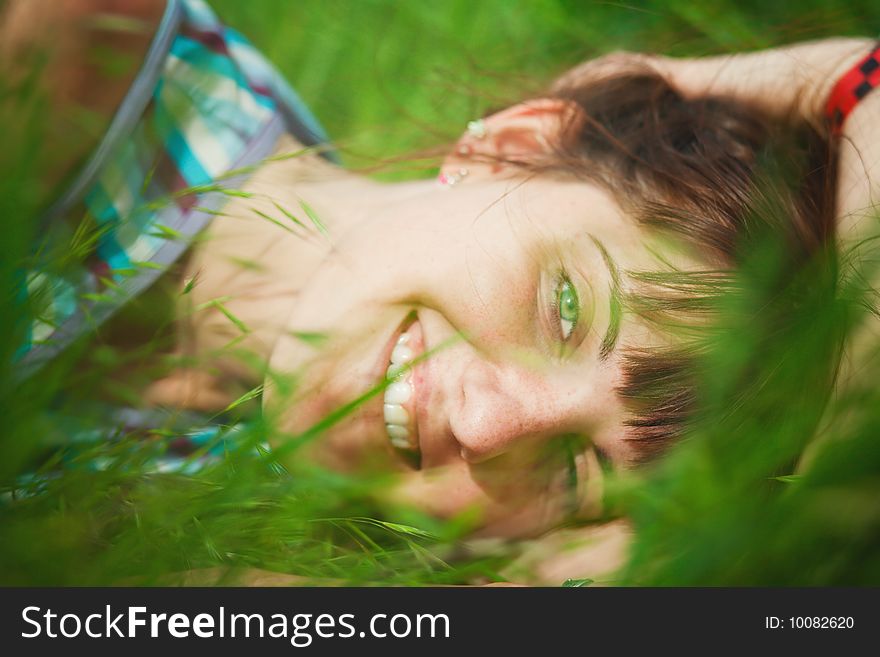 Young smiling girl lying in grass