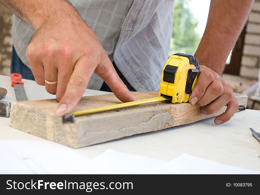 Measuring of wood board close-up