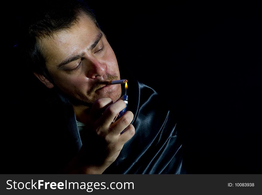 Man is lighting a cigarette