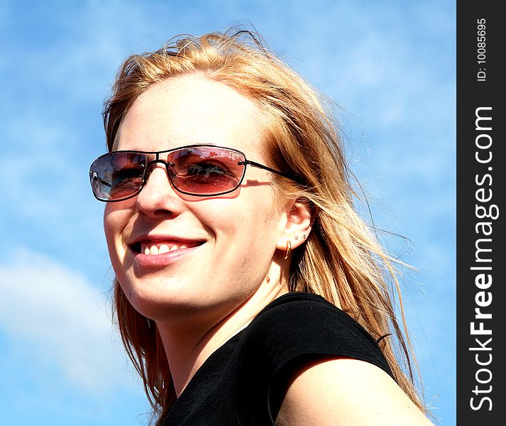 A young, blond woman with sun glasses. A young, blond woman with sun glasses