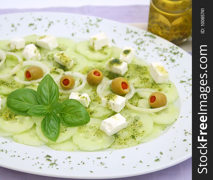 A fresh salad of cucumbers with olives and cheese