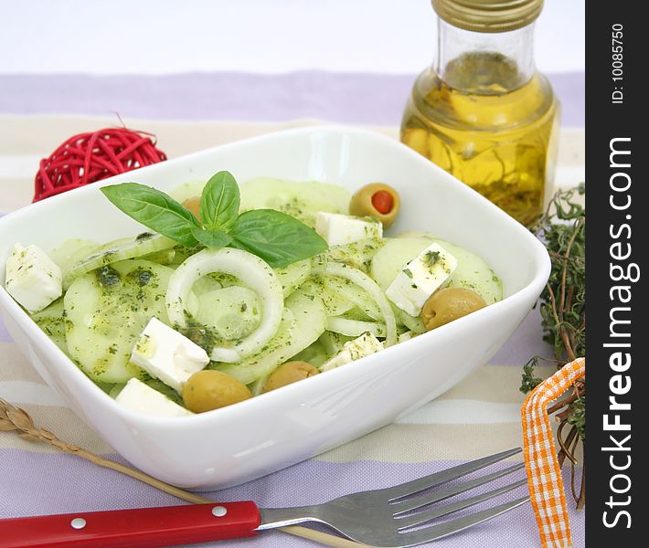 A fresh salad of cucumbers with onions, cheese and olives. A fresh salad of cucumbers with onions, cheese and olives