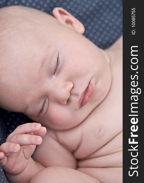 A precious baby sound asleep in an awkward position, focus on the hand. A precious baby sound asleep in an awkward position, focus on the hand.