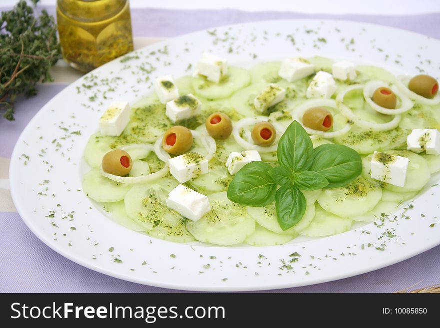 A fresh salad of cucumbers with olives and cheese