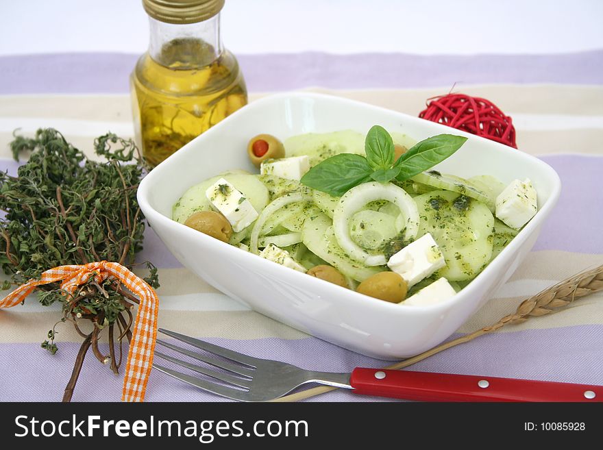 A fresh salad of cucumbers with olives and cheese