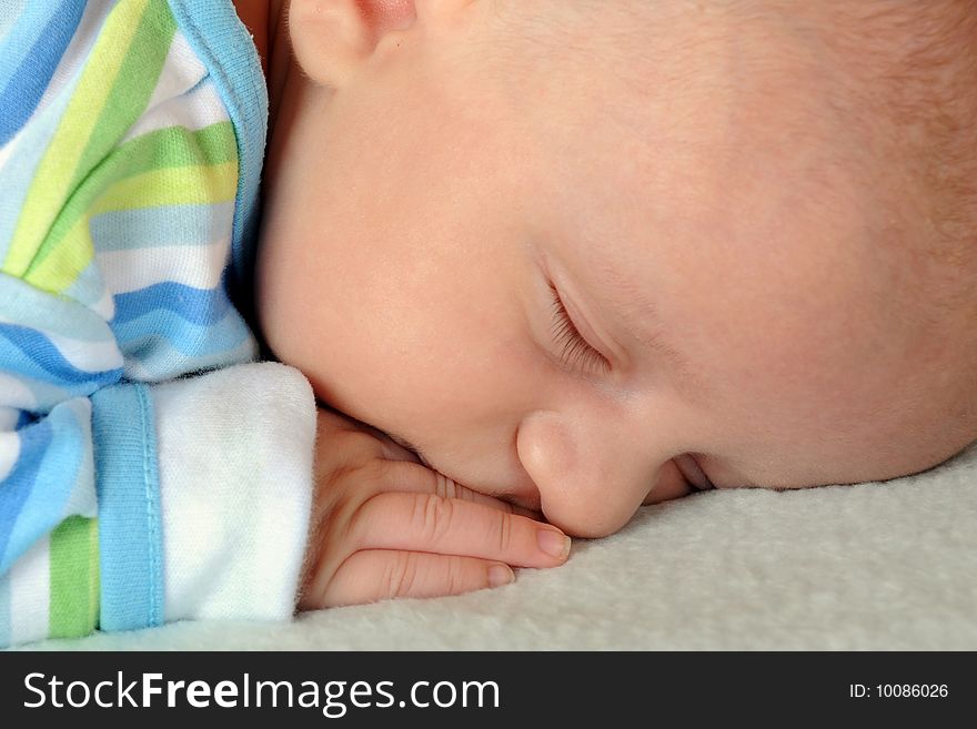 A close up portrait of a sleeping infant. A close up portrait of a sleeping infant.