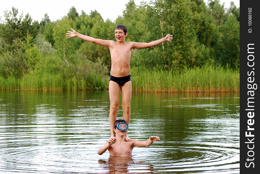 Boys showing their balance abilities in a lake. Boys showing their balance abilities in a lake.