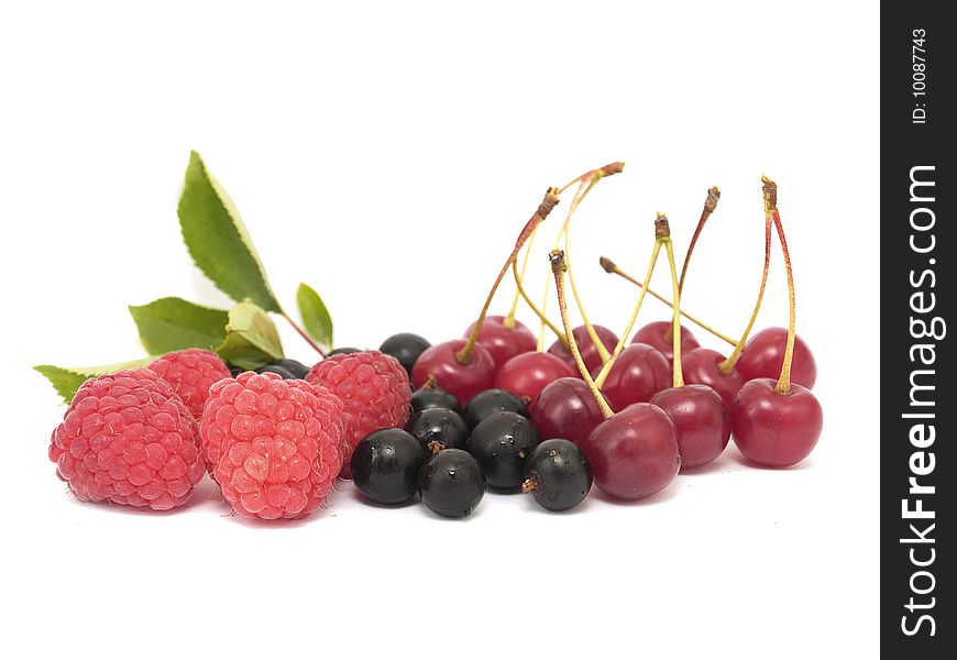Raspberries, cherries and black currant isolated on white