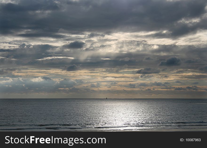 Sun on the beach with a boat in the horizon. Sun on the beach with a boat in the horizon