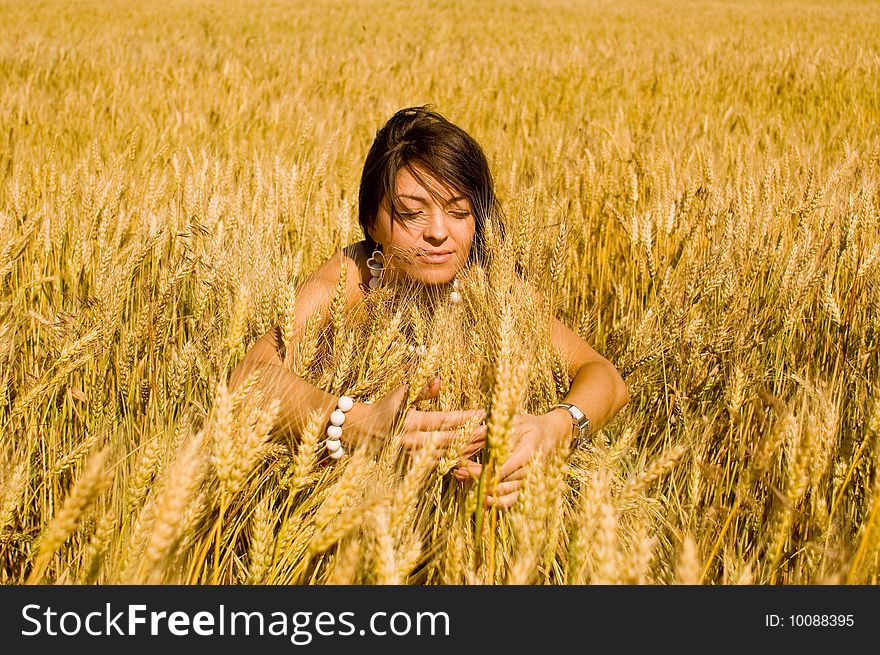 Young model in dress in the field of wheat. Young model in dress in the field of wheat