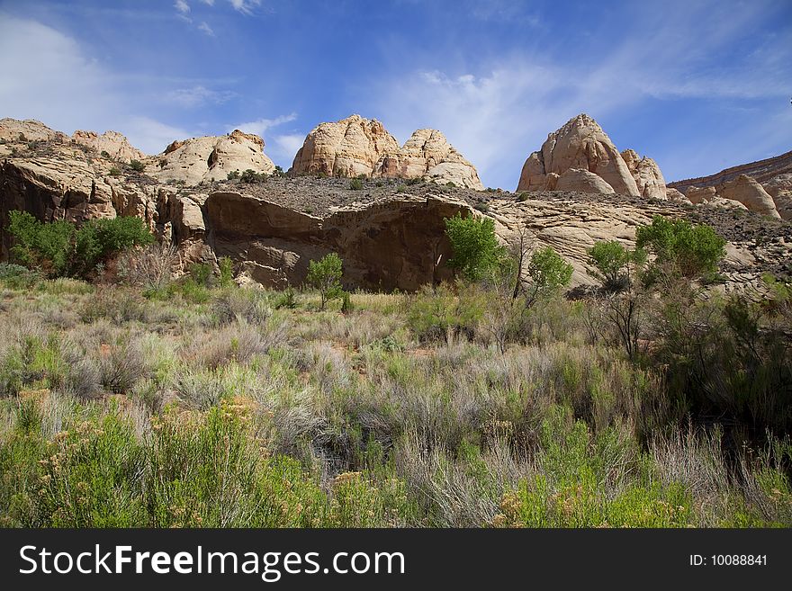 View of the red rock formations in Capitol Reef National Park with blue skyï¿½s and clouds