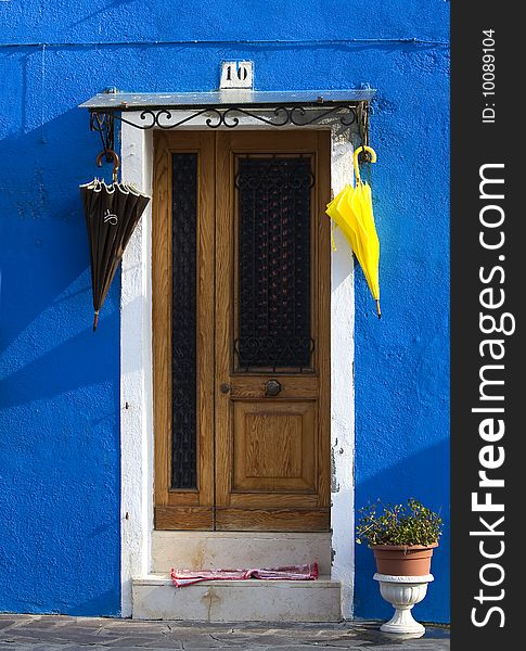 Umbrella hung door and blue wall