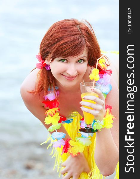 Attractive girl with glass of juice on sea background