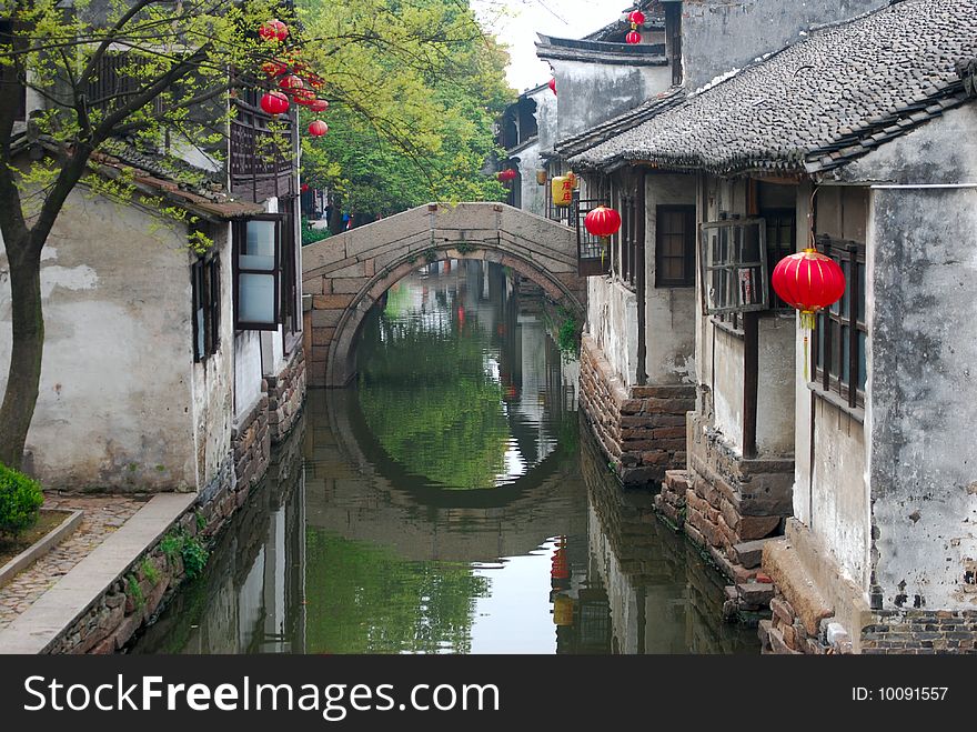 A bridge with its reflection make a beautiful sense in Chinese old water towm .