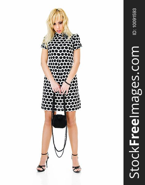 Young sad woman in spotted dress on white