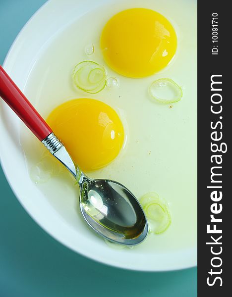 Yolks and spoon on plate.