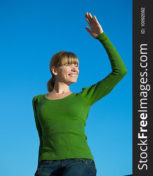 Portrait of the young woman posing on a background of the dark blue sky. Portrait of the young woman posing on a background of the dark blue sky