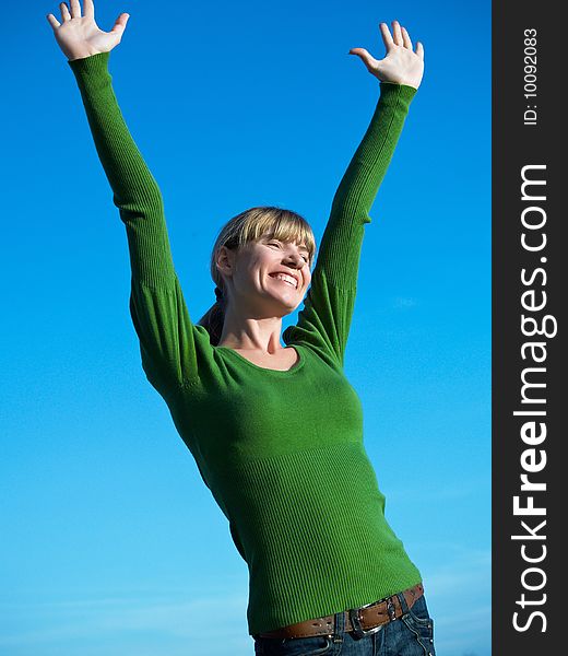 Portrait of the young woman posing on a background of the dark blue sky. Portrait of the young woman posing on a background of the dark blue sky