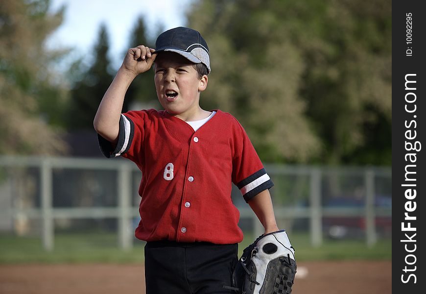 This young baseball player puts lots of energy into the game and claims he is the best player on the team. This young baseball player puts lots of energy into the game and claims he is the best player on the team.