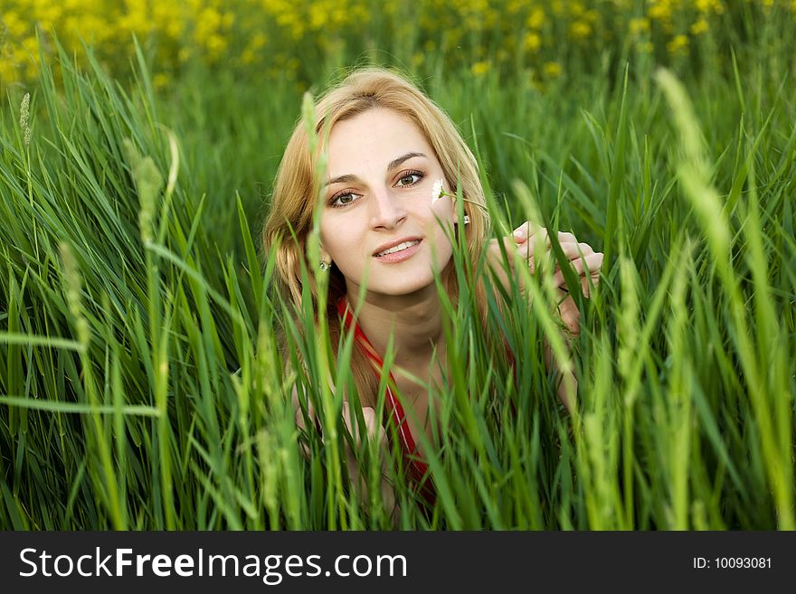 An image of a young girl in green grass. An image of a young girl in green grass