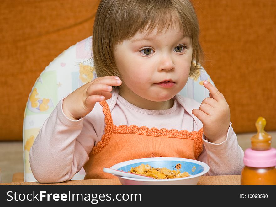 Sweet toddler baby girl eating