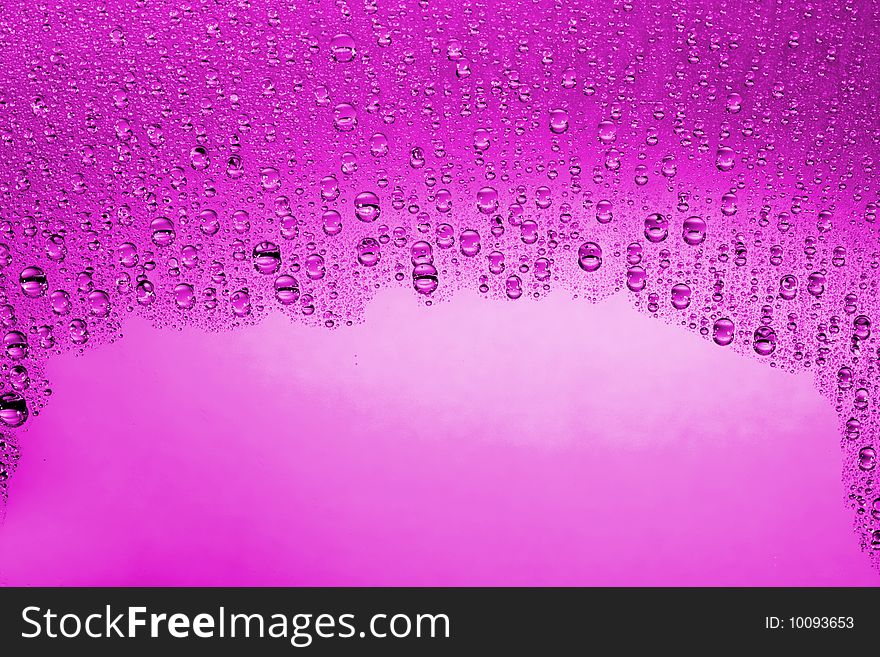 Pink water drops against black background