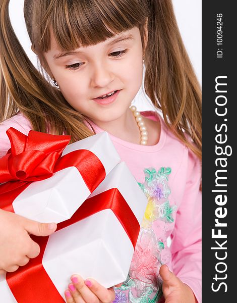 Adorable little girl with white gift box