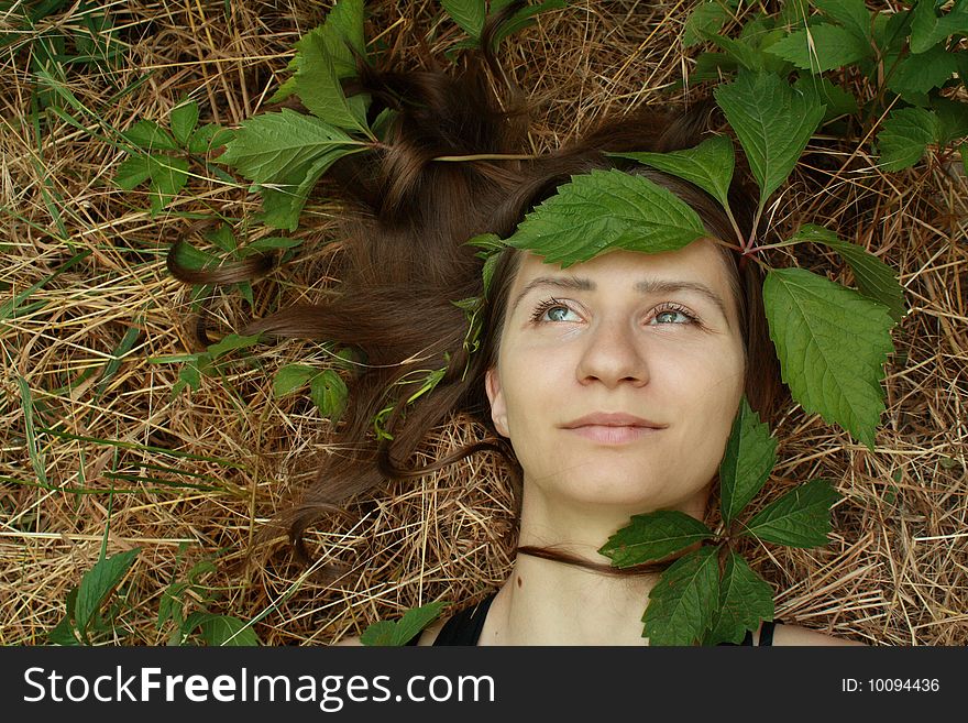 The young girl and leaves of wild grapes. The young girl and leaves of wild grapes