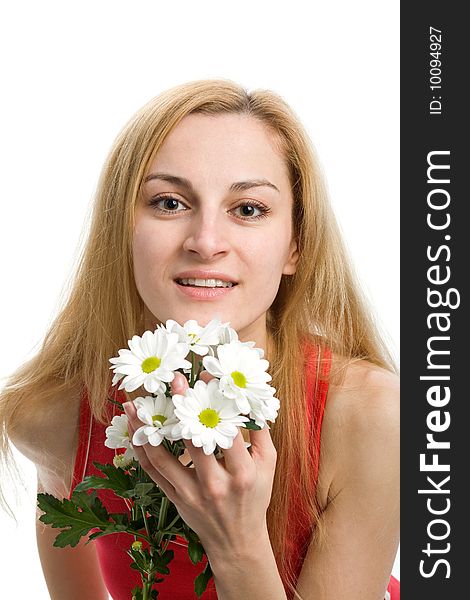 A smiling beautiful girl in red with a bouquet of white chrysanthemums in her hands. A smiling beautiful girl in red with a bouquet of white chrysanthemums in her hands