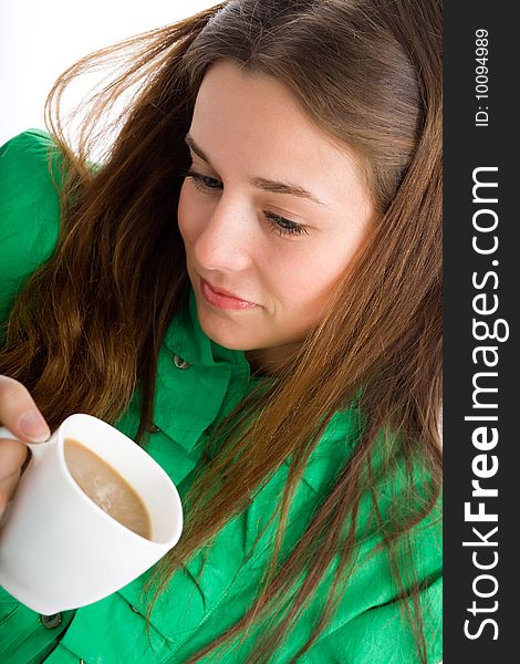 An attractive young woman with a coffee cup in her hands. An attractive young woman with a coffee cup in her hands