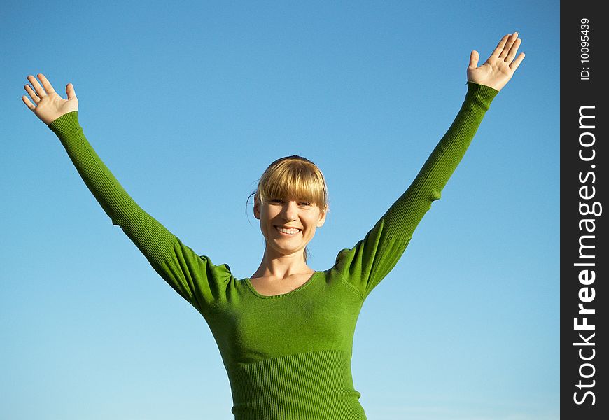 Portrait of the young woman posing on a background of the dark blue sky. Portrait of the young woman posing on a background of the dark blue sky