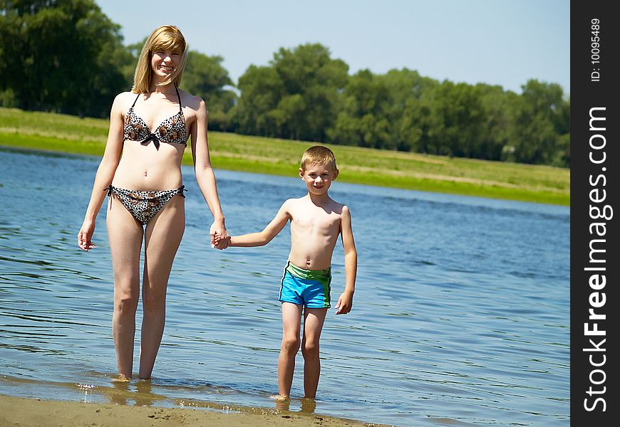 Young mum plays with the son on the nature. Young mum plays with the son on the nature