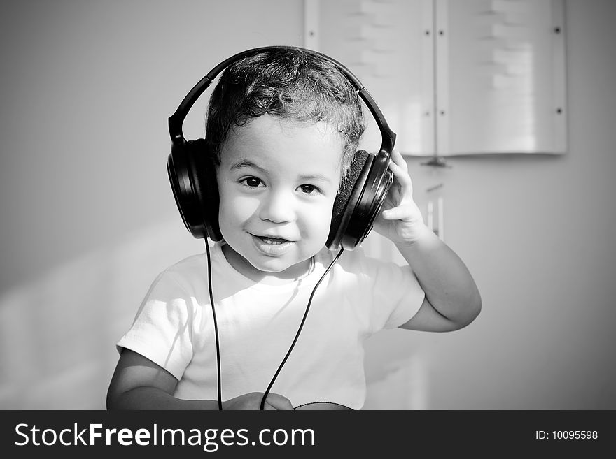 Young boy in big black headphones. Young boy in big black headphones