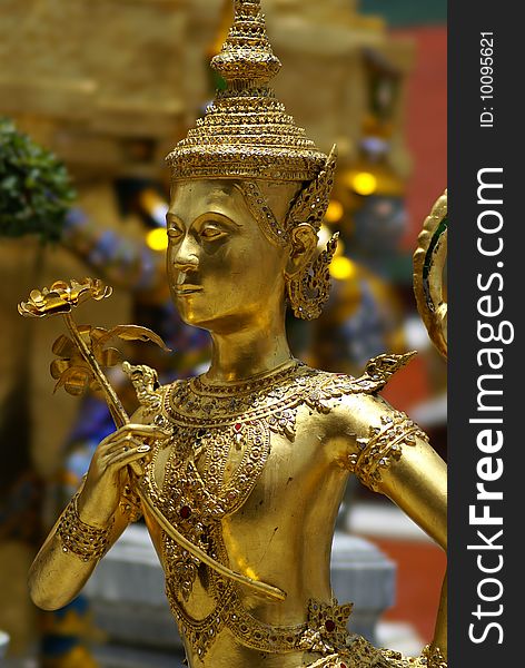 A golden tahi angel statue inside grand palace in Bangkok. A golden tahi angel statue inside grand palace in Bangkok