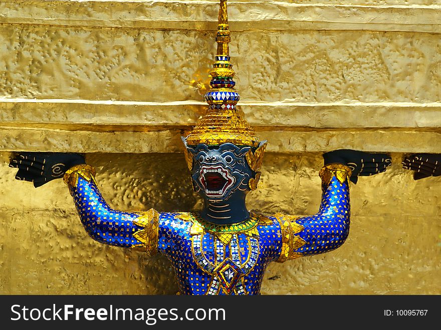 A golden tahi angel statue inside grand palace in Bangkok. A golden tahi angel statue inside grand palace in Bangkok