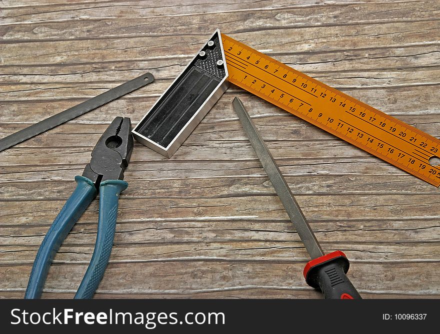 Technician's tools on old wood background