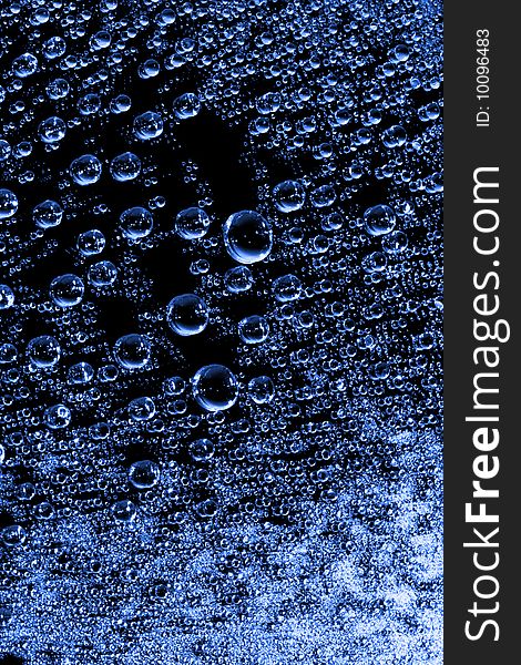Blue water drops against black background
